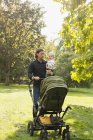 Man holding baby carriage — Stock Photo
