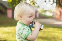 Cute baby boy drinking — Stock Photo
