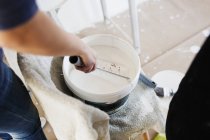 Human hand dipping paint roller — Stock Photo
