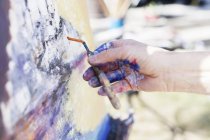Artist using painting knife — Stock Photo