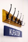 Name sign hanging on wall hook — Stock Photo