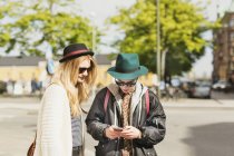 Young man and woman standing on street — Stock Photo