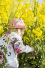 Girl at rapeseed field — Stock Photo