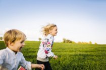 Cheerful siblings running — Stock Photo