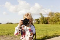 Girl photographing through camera — Stock Photo