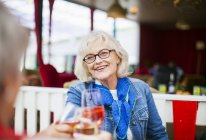 Senior women smiling and toasting — Stock Photo