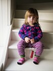 Portrait of girl sitting on staircase — Stock Photo
