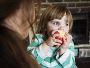 Mère avec sa fille mangeant des pommes — Photo de stock
