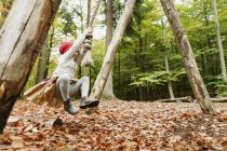 Girl swinging in forest — Stock Photo