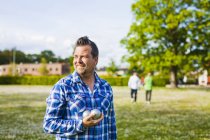 Man holding boule balls at park — Stock Photo