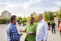 Male friends talking while playing boule — Stock Photo