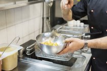 Chef preparing food in restaurant — Stock Photo