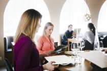 People reading menu while sitting at table — Stock Photo