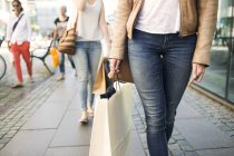 Friends with shopping bags on street — Stock Photo