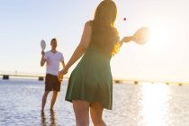Couple playing with racquet and ball — Stock Photo