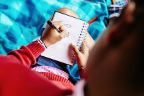 Wniversity student writing at park — Stock Photo