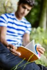 Young man studying in park — Stock Photo