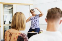 Teacher explaining students in classroom — Stock Photo