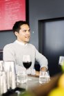 Young man sitting at restaurant — Stock Photo