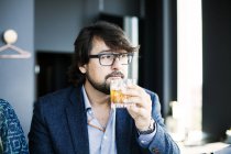 Man drinking whisky in restaurant — Stock Photo