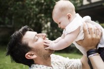 Young father carrying baby girl — Stock Photo