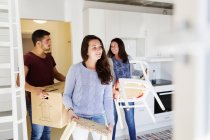 Young friends moving furniture — Stock Photo