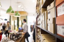 Boxes on shelves and people — Stock Photo