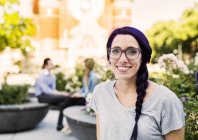Young woman smiling on street — Stock Photo