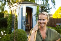 Жінка з виделкою для садівництва дивиться — стокове фото