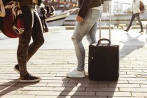 Female students with luggage standing — Stock Photo