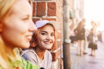 Young women sitting on street — Stock Photo