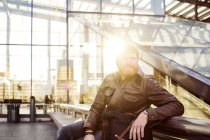 Man sitting outside central station — Stock Photo