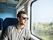 Thoughtful man in sunglasses — Stock Photo