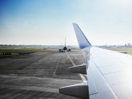 Airplanes on airport runway — Stock Photo