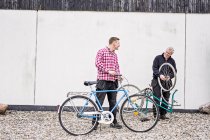 Отец и сын ремонтируют велосипеды — стоковое фото