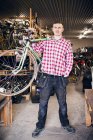 Owner carrying bicycle — Stock Photo