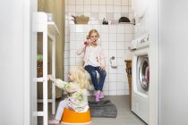 Girl sitting on potty trainer — Stock Photo