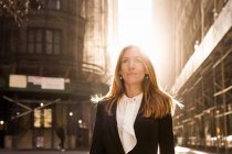 Businesswoman standing against buildings — Stock Photo