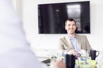 Businessman sitting at conference table — Stock Photo