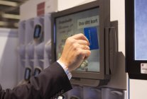 Male hand swiping credit card — Stock Photo