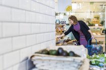 Woman buying bread in supermarket — Stock Photo