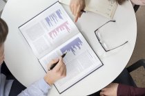 Business people analyzing graphs — Stock Photo