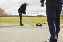 Amici che praticano il golf — Foto stock