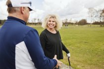 Friends talking while playing golf — Stock Photo