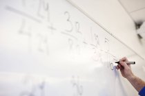 Teacher solving mathematical equation — Stock Photo