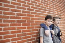 Schoolboys standing in front of building — Stock Photo