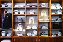 Shirts arranged in shelves — Stock Photo