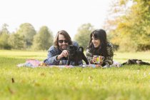 Happy young couple with puppy — Stock Photo