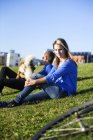 Woman sitting with man and dog — Stock Photo