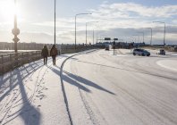 Women walking on snow covered sidewalk — Stock Photo